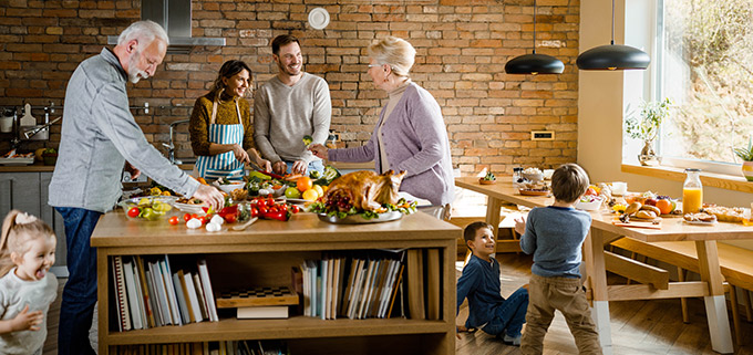 Large family gathering in kitchen for holidays