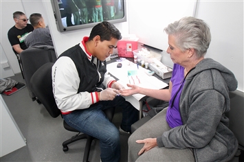 A community member receives a health screening in the Care Van